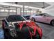 Garage showcasing luxury cars with ample space for parking and storage at 464 Beardsley Cir, Henderson, NV 89052