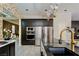 Modern kitchen featuring stainless steel appliances, stylish countertops, and unique lighting at 464 Beardsley Cir, Henderson, NV 89052