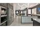 Modern kitchen with stainless steel appliances, granite countertops and large island open to living room at 464 Beardsley Cir, Henderson, NV 89052