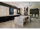 Sleek kitchen with black cabinets, white countertops and modern lighting at 464 Beardsley Cir, Henderson, NV 89052