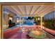 Inviting backyard with a pergola covered patio, pool, and unique fire pit area at 464 Beardsley Cir, Henderson, NV 89052