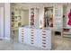 Elegant walk-in closet with ample storage, custom shelving, and marble floors, perfect for organizing your wardrobe at 464 Beardsley Cir, Henderson, NV 89052