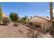 Spacious backyard with desert landscaping and covered patio, offering a relaxing outdoor space at 5028 Glenarden Dr, Las Vegas, NV 89130