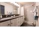 Bathroom with dual sinks, white marble walk-in shower with gray accents, and modern fixtures at 5028 Glenarden Dr, Las Vegas, NV 89130