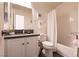 Bathroom featuring a vanity with sink, toilet, and bathtub/shower with curtain and white tiling at 5028 Glenarden Dr, Las Vegas, NV 89130