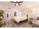 Bedroom with a ceiling fan, natural light, and neutral decor for a relaxing atmosphere at 5028 Glenarden Dr, Las Vegas, NV 89130