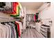 Walk-in closet, wood-style laminate flooring with ample hanging and shelf space for storage and organization at 5028 Glenarden Dr, Las Vegas, NV 89130
