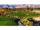 Expansive golf course with green fairways and manicured landscaping, nestled against a backdrop of mountains at 5028 Glenarden Dr, Las Vegas, NV 89130