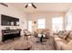 Bright living room featuring a piano, neutral-toned furniture, and lots of natural light at 5028 Glenarden Dr, Las Vegas, NV 89130