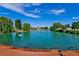 Beautiful pond with a fountain, surrounded by mature trees and lush landscaping at 5028 Glenarden Dr, Las Vegas, NV 89130
