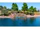 Picturesque pond with a rock waterfall feature, surrounded by lush greenery and trees at 5028 Glenarden Dr, Las Vegas, NV 89130