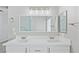 Bathroom featuring dual sinks, a large mirror, and marble-look tiled accents at 5116 Iron Crossing Ave, Las Vegas, NV 89131