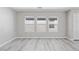 Bedroom with windows, gray plank flooring, and neutral colored walls at 5116 Iron Crossing Ave, Las Vegas, NV 89131