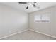 Minimalist bedroom with neutral carpet and a window providing natural light at 5116 Iron Crossing Ave, Las Vegas, NV 89131