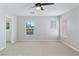 Well-lit bedroom featuring neutral carpet, dual windows, and a modern ceiling fan at 5116 Iron Crossing Ave, Las Vegas, NV 89131