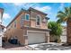 Two-story home featuring a two car garage and desert landscaping at 5116 Iron Crossing Ave, Las Vegas, NV 89131