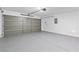 Spacious garage with epoxy flooring and an insulated gray door, offering ample parking and storage space at 5116 Iron Crossing Ave, Las Vegas, NV 89131