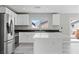 Bright kitchen with white cabinets, stainless steel appliances, and granite countertops at 5116 Iron Crossing Ave, Las Vegas, NV 89131