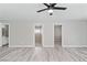Spacious living room featuring light gray wood-look floors with multiple doorways at 5116 Iron Crossing Ave, Las Vegas, NV 89131
