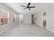Spacious living room featuring modern ceiling fan and light gray wood-look flooring at 5116 Iron Crossing Ave, Las Vegas, NV 89131