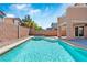 Sparkling pool with a built-in spa, surrounded by lush landscaping and a privacy wall, perfect for enjoying sunny days at 5116 Iron Crossing Ave, Las Vegas, NV 89131