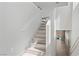 Bright, freshly painted staircase leading to the upper level with wood-look steps and modern white railings at 5116 Iron Crossing Ave, Las Vegas, NV 89131