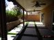 Back patio with concrete pavers, artificial turf, planters, and a ceiling fan at 5889 Thistle Meadow Ave, Las Vegas, NV 89139