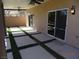 Back patio with pavers, artificial turf, retaining wall, and a ceiling fan at 5889 Thistle Meadow Ave, Las Vegas, NV 89139
