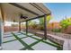 Back patio with ceiling fan, landscaping, and privacy wall at 5889 Thistle Meadow Ave, Las Vegas, NV 89139