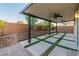 Covered back patio with landscaping and privacy wall at 5889 Thistle Meadow Ave, Las Vegas, NV 89139