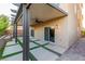 Covered back patio with custom landscaping, and sliding glass doors to the interior at 5889 Thistle Meadow Ave, Las Vegas, NV 89139