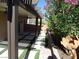 Covered backyard patio featuring decorative hardscape and a lush garden area, ideal for outdoor entertaining at 5889 Thistle Meadow Ave, Las Vegas, NV 89139