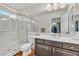 Bright bathroom featuring a glass-enclosed shower, vanity with marble countertop, and modern fixtures at 5889 Thistle Meadow Ave, Las Vegas, NV 89139