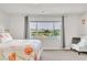 Bright bedroom featuring a large window with mountain views and a comfortable seating area at 5889 Thistle Meadow Ave, Las Vegas, NV 89139