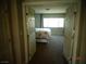 Bedroom view from the doorway featuring carpet, queen bed, and window at 5889 Thistle Meadow Ave, Las Vegas, NV 89139