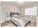 Comfortable bedroom with a plush bed, decorative accents, and soft natural light at 5889 Thistle Meadow Ave, Las Vegas, NV 89139