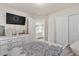 Spacious bedroom featuring a TV, closet, dresser, and comfortable bedding at 5889 Thistle Meadow Ave, Las Vegas, NV 89139