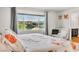 Bright bedroom featuring a large window with neighborhood views, complemented by a comfortable armchair at 5889 Thistle Meadow Ave, Las Vegas, NV 89139