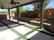 Beautiful covered patio featuring custom pavers, a stone wall, and lush landscaping at 5889 Thistle Meadow Ave, Las Vegas, NV 89139