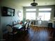 Well-lit dining room features an elegant dining table set, modern lighting, and dark wood floors at 5889 Thistle Meadow Ave, Las Vegas, NV 89139