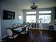 Well-lit dining room features an elegant dining table set, modern lighting, and dark wood floors at 5889 Thistle Meadow Ave, Las Vegas, NV 89139