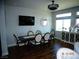 Well-lit dining room features an elegant dining table set, modern lighting, and dark wood floors at 5889 Thistle Meadow Ave, Las Vegas, NV 89139
