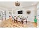 Bright dining room with modern ceiling fan, stylish chairs, and a view of the staircase and adjacent living spaces at 5889 Thistle Meadow Ave, Las Vegas, NV 89139