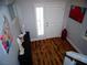 View of the home's entryway, featuring hardwood floors, art decor, and a front door with window at 5889 Thistle Meadow Ave, Las Vegas, NV 89139