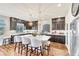 Stylish kitchen featuring dark cabinetry, a granite island with seating, and stainless steel appliances at 5889 Thistle Meadow Ave, Las Vegas, NV 89139