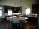 Spacious kitchen with a large center island, pendant lighting, and dark wood cabinets at 5889 Thistle Meadow Ave, Las Vegas, NV 89139