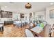 Spacious kitchen and dining area with dark cabinets, stainless appliances, and eat-in island with barstool seating at 5889 Thistle Meadow Ave, Las Vegas, NV 89139