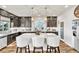 Modern kitchen with granite countertops, stainless appliances, eat-in island, and dark cabinetry at 5889 Thistle Meadow Ave, Las Vegas, NV 89139