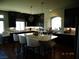 Spacious kitchen features dark cabinetry, granite countertops and a large island at 5889 Thistle Meadow Ave, Las Vegas, NV 89139