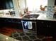 Stove and counter top of kitchen boasts granite counters, mosaic backsplash and decor at 5889 Thistle Meadow Ave, Las Vegas, NV 89139